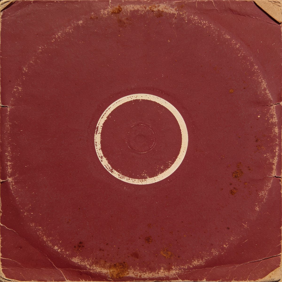 A worn oxblood record sleeve with a pale ring worn into it