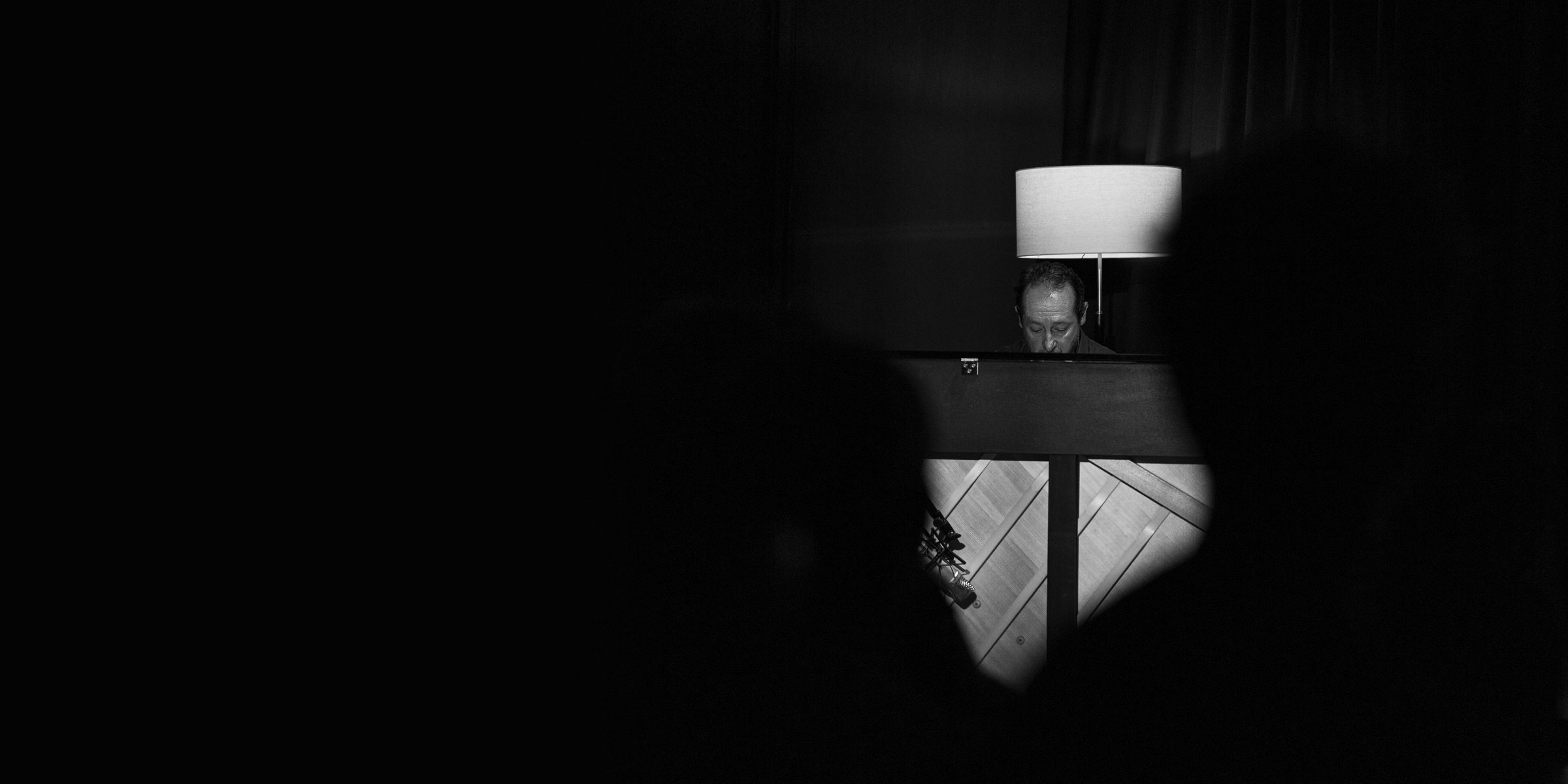 Sleeve Notes Nº.001 — Chad Lelong at the piano under a single lamp