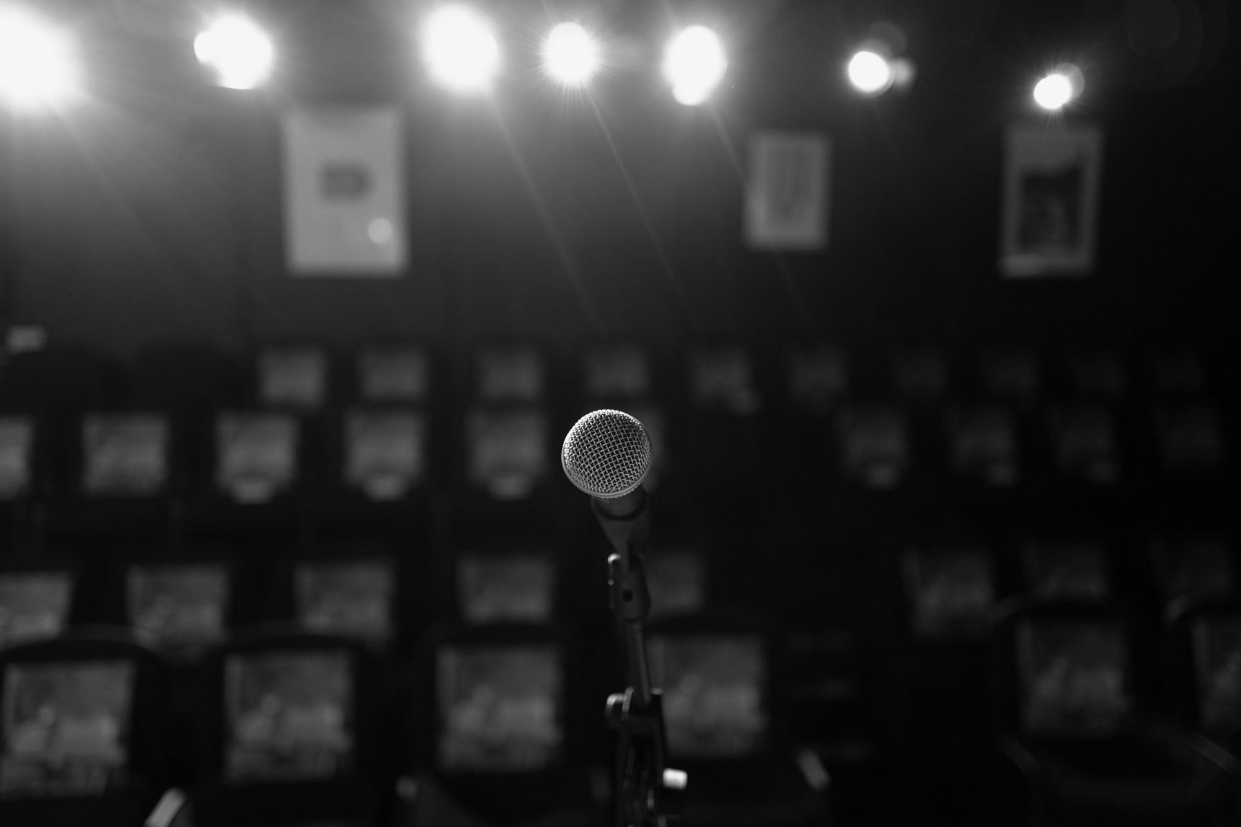 From behind the mic — fifty-five seats, every one close